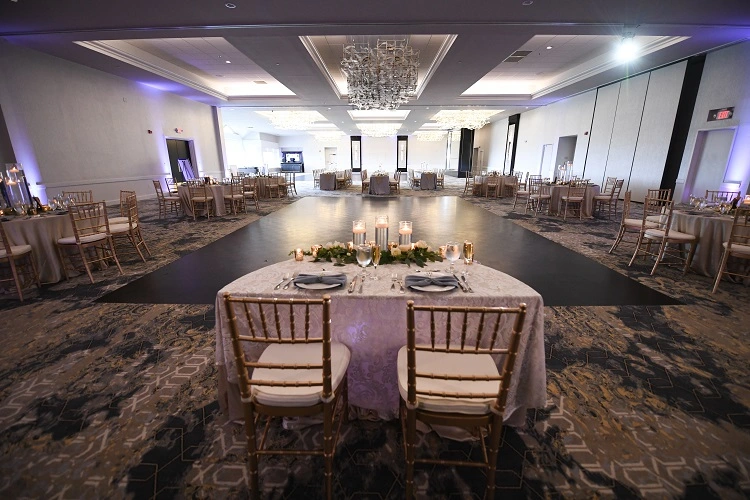 His and hers bride and groom chairs overlooking entire banquet hall